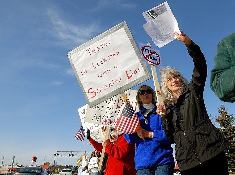 Carol Barnes, right, and Carol Nelson stand on Main Street in Kalispell Saturday afternoon along with hundreds of others against big government, big spending and pending health care legislation. The rally coincided with an appearance by Sen. Jon Tester, D-Mont., at the Flathead County Democratic Party&#146;s spring dinner at the nearby Red Lion Hotel.