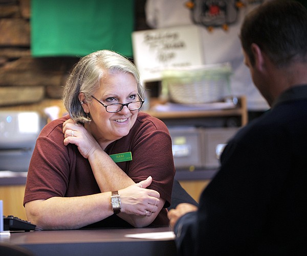 Brenda Ahearn/Daily Inter Lake
Terri Muraoka of the Whitefish Credit Union talks with Travis Tveidt of Whitefish on Thursday.