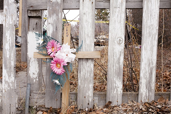 &lt;p&gt;A small cross that reads, &quot;RIP John&quot; was placed outside John Parsons home on Ninth Avenue West. Monday, March, 12, 2012 in Kalispell, Mont.&lt;/p&gt;