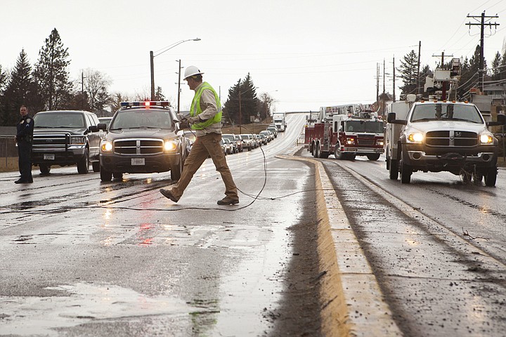 &lt;p&gt;Danny Johnson of Flathead Electric Cooperative removes a downed power line from the middle of U.S. 93 near Wyoming Street in Kalispell on Tuesday morning. High winds caused the line to detach from a power pole.&#160;&lt;/p&gt;