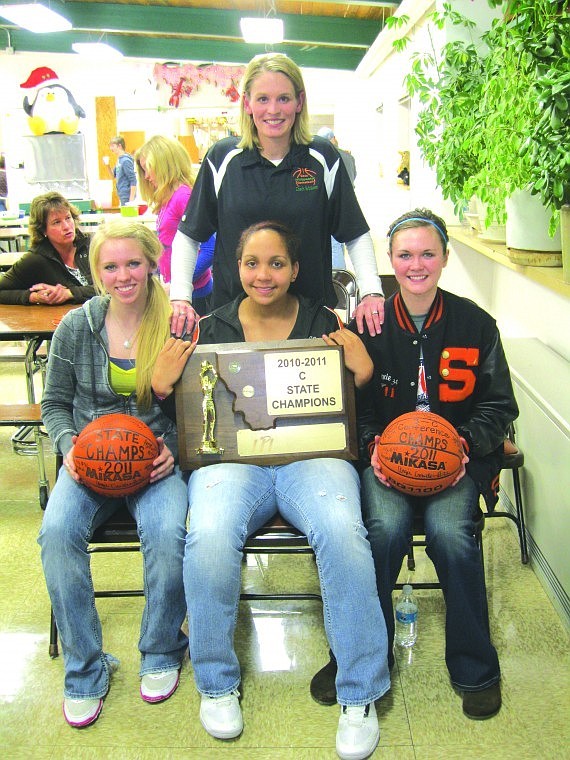 Coach Amber Erickson and the team's three seniors: Macey Cox, Jessie Davis and Annie Depuydt. Erickson graduated from Superior and coached her team to a state championship this year.