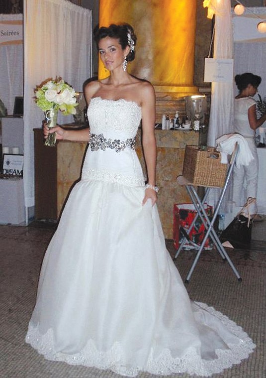 Karol Scott-Tracy dons a wedding gown to prepare for a modeling session in Miami.