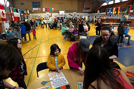 &lt;p&gt;Event goers make bracelets with beads representing different countries, as others wander amongst food and music.&lt;/p&gt;