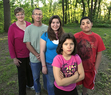 &lt;p&gt;In this May 5, 2010, file photo, Mary and Joe Thompson stand with their children Sarah, center, Andrew, right, and Emily, front, at their home in Overland Park, Kan. Mary Thompson was sure the health care law would finally let them get Emily on the family's health insurance. Insurers had repeatedly rejected Emily due to a birth defect now largely overcome. The law requires insurers to accept children regardless of pre-existing health problems, a safeguard that will extend to people of all ages in 2014. But because Emily's father is self-employed and the family buys its own coverage, things didn't work out as expected.&lt;/p&gt;