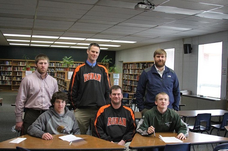 <p>The Ronan football coaching staff — Brendon Decock, Tom Peterson, Jim Benn and Ryan Wells — pose with their two players that just signed their letters of intent to play college football.</p>