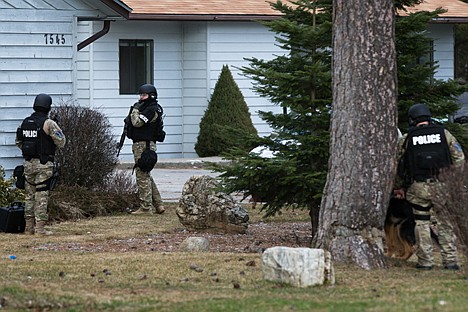 &lt;p&gt;Post Falls Police Special Response officers surround an apartment building on North Pine Street in Rathdrum Friday where 27 year old Post Falls resident Johnathon Raper sought refuge after instigating a car chase with police.&lt;/p&gt;