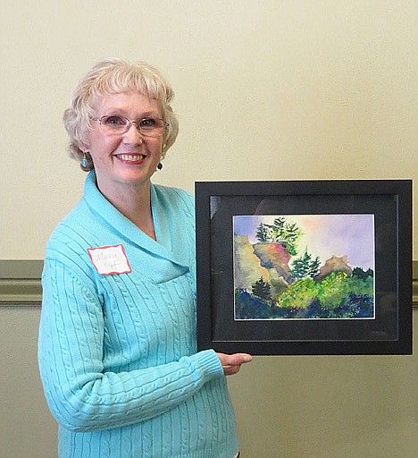 <p>Mary Kopf with the painting she donated for raffle at the show.</p>