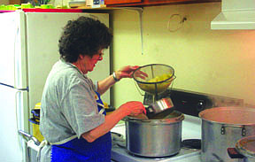 Sherrill Christensen works in the kitchen. Here, she works on preparing the cabbage.