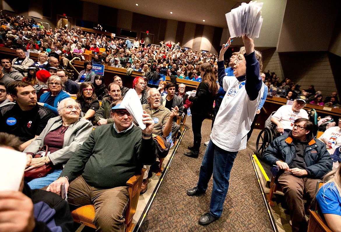 &lt;p&gt;Kristy Johnson holds up ballots as she collects them from democrats casting their votes for their preferred presidential candidate on Tuesday at the Democratic caucus held at North Idaho College. About 1,150 people showed up to caucus.&lt;/p&gt;