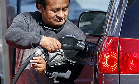 &lt;p&gt;A gas station attendant pumps gas Friday in Portland, Ore. Oil prices briefly spiked to the highest level in three weeks following a report that Iranian oil exports dropped significantly this month.&lt;/p&gt;