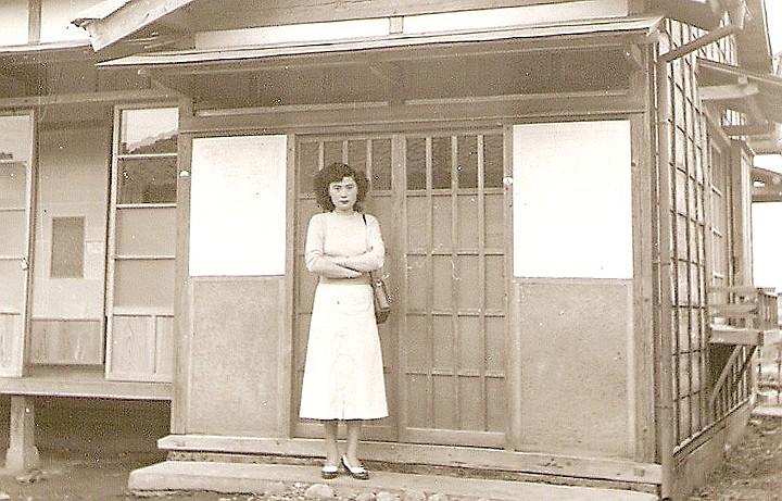 Betty Treacy's late mother, Akiko Treacy, stands in front of a structure in Japan in 1953 or 1954.