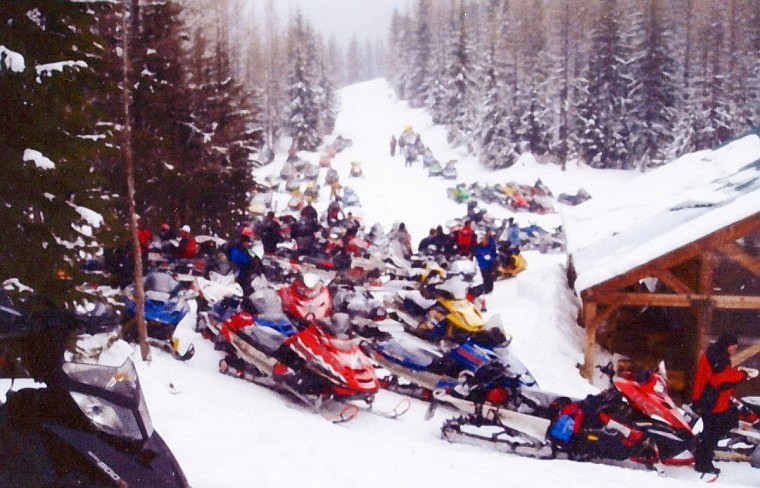 Snowmobiles are parked next to the warming shed built by the club in 2008.