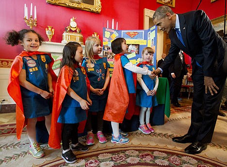 &lt;p&gt;Dressed in superhero capes, six-year-old Girl Scouts, from left, Alicia Cutter, Addy O'Neal, Emery Dodson, Karissa Cheng and Emily Bergenroth, of Tulsa, Okla., meet with President Barack Obama before showing him their project during his tour of the White House Science Fair, Monday. The girls used Lego pieces and designed a battery-powered page turner to help people who are paralyzed or have arthritis.&#160;&lt;/p&gt;