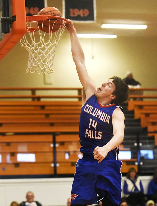 <p>Columbia Falls' Kyler Burns throws down a dunk during the dunk contest of the Les Schwab Shootout at Flathead High on Thursday. Burns won the contest. (Aaric Bryan/Daily Inter Lake)</p>