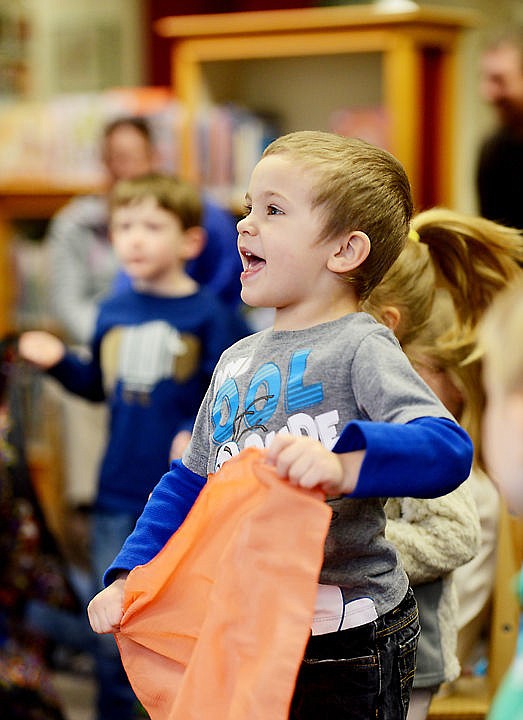<p>Calem Steward, 3 of Kalispell, and other children dance along with the music at Storytime at ImagineIF Library in Kalispell on Tuesday, March 22.</p>