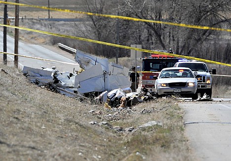 &lt;p&gt;The wreckage of single engine plane involved in a mid-air collision is seen on the side of Weld CR 1 on Friday near Great Western Drive near Longmont, Colo.&lt;/p&gt;