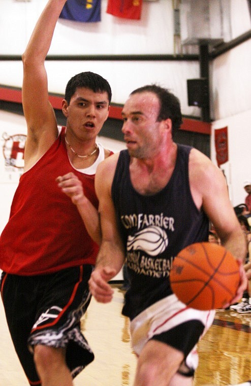 Lenny Page of Lonepine drives hard to the hoop during a basketball game on Saturday.