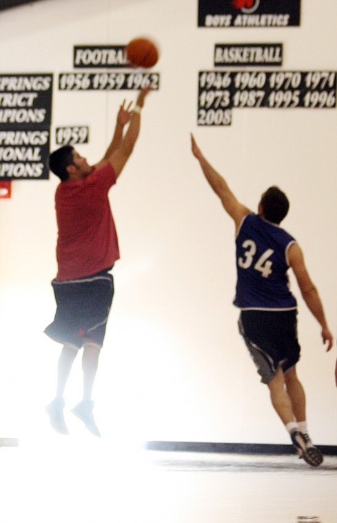 Jim Lawson, right, jumps up to defend a jump shot. Lawson is the man behind the madness of the tournament.