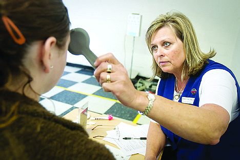 &lt;p&gt;Kathy Teall, an employee of North Idaho Eye Institute, conducts a vision check Wednesday morning at the New Vision High School Wellness Day in Post Falls.&lt;/p&gt;