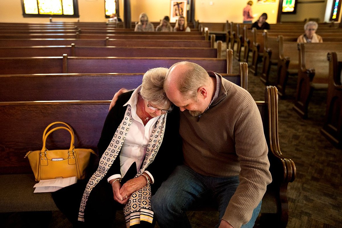 &lt;p&gt;Karen Yates is comforted and offered words of prayer by First Presbyterian Church pastor Craig Sumy on Thursday during the church's Stations of the Cross gathering in Coeur d'Alene.&lt;/p&gt;