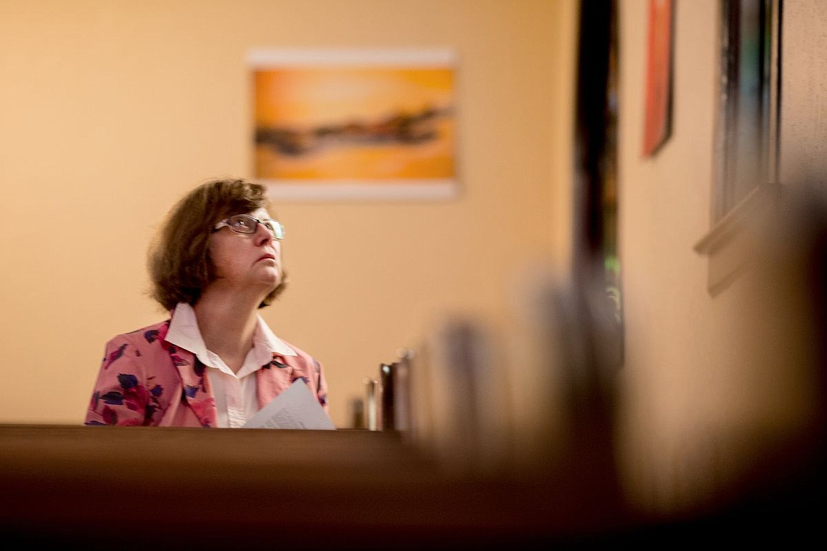 &lt;p&gt;Kay Mills of Coeur d'Alene gazes up at the stained glass windows at the First Presbyterian Church in Coeur d'Alene while reflecting during the church's Stations of the Cross ceremony on Thursday.&lt;/p&gt;