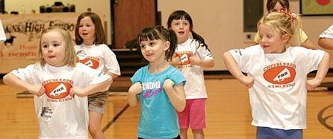 Photos by Ed Moreth The youngest group of cheerleaders show their &#147;Chicken Dance&#148; cheer during practice. From the left: Kaylee Cole, Alyson Garcia and Celsey VonHeeder.