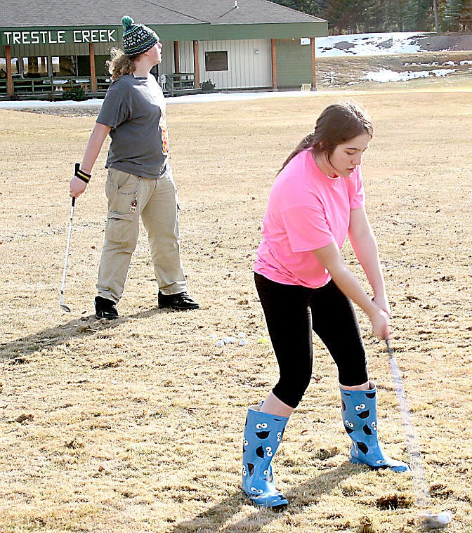 &lt;p&gt;Senior Keenan Clute tracks his ball's progress as junior Ashley Chessman swings for a shot of her own during one of the first practice sessions of the St. Regis golf team.&#160;&lt;/p&gt;