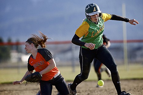 &lt;p&gt;Lakeland High's Bekah Kastning races to third base after running into Post Falls shortstop Kyra Haskew as she made a play on the ball. Haskew was called out on the play after the collision was ruled interference.&lt;/p&gt;