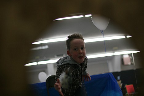 &lt;p&gt;Keegan Riggs, 7, launches a beanbag bone at the mouth of a cardboard dog Saturday during the Furr Fever Family Festival at the Kootenai County Fairgrounds. Games like the beanbag toss helped raise more than $5,000 for the society. Keegan nailed the shot six times.&lt;/p&gt;