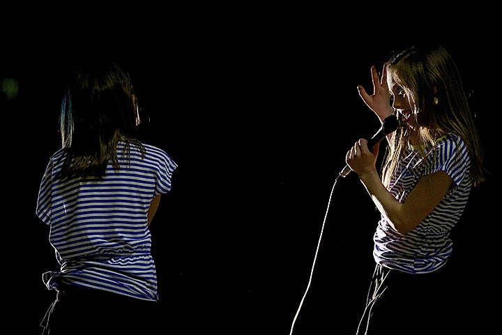 &lt;p&gt;JEROME A. POLLOS/Press Emily Johnson has the spotlight on her as she sings with her Westridge Elementary classmate Galexi Dunbar during the school's talent show Wednesday in Post Falls.&lt;/p&gt;