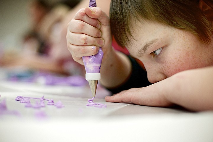 &lt;p&gt;JEROME A. POLLOS/Press Christian Stone, 11, focuses on creating a design with a fine tip, cake decorating tip Tuesday during the Spartan Quest after school learning program at Post Falls Middle School. Students were able to take part in classes such as yoga, fishing, cake decorating and horse grooming during the Tuesday after school program that ends on March 19.&lt;/p&gt;