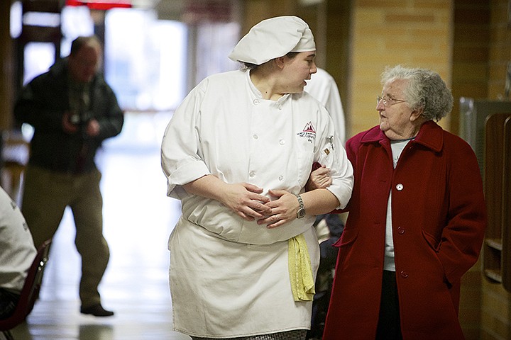 &lt;p&gt;JEROME A. POLLOS/Press Joan McKeown walks back to the bus waiting for her after lunch Thursday as she is escorted by Amy Whitten, a culinary arts student from North Idaho College. The team of culinary arts students working at Emery&#146;s Restaurant hosted the lunch for residents of Coeur d&#146;Alene Homes assisted living facility.&#160; This was a community service project to help them understand the processes of assisting and serving elderly clientele when students transition into working in a restaurant.&lt;/p&gt;