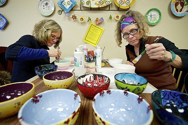 &lt;p&gt;JEROME A. POLLOS/Press Jane Scott, left, and her sister Judy Nicholson paint bowls Friday to go along with the eight they already crafted at Hands to Art in Coeur d'Alene for the upcoming Empty Bowl Dinner fundraiser for local food banks.&lt;/p&gt;