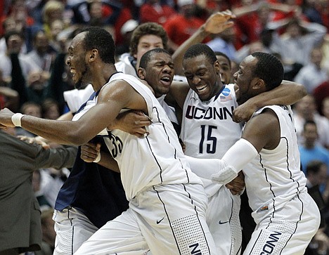 &lt;p&gt;Connecticut teammates celebrate a 65-63 win over Arizona in the West Regional championship game Saturday in Anaheim, Calif.&lt;/p&gt;