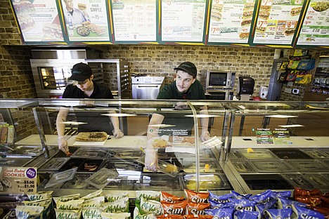 &lt;p&gt;Sandwich artists Patrick Runkle, left, and Brad McNelis work on a customer order Tuesday at Subway in Coeur d'Alene. The sandwich shop, that opened in its new location on Monday, recently moved from Northwest Boulevard to Sherman Avenue.&lt;/p&gt;