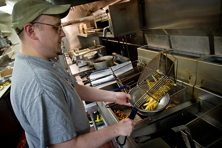 &lt;p&gt;John Reagan, a cook at Capone's Pub &amp; Grill, removes an order of fries from a deep fryer Friday at the Coeur d'Alene eatery. Restaurants owners are being asked to do more to alleviate clogging problems due to grease and oils.&lt;/p&gt;