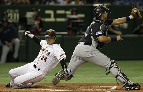 &lt;p&gt;Japan?s Yomiuri Giants Yoshinobu Takahashi, left, slides into the home plate as Seattle Mariners catcher Jesus Montero in the second inning during their exhibition game at Tokyo Dome in Tokyo Monday, March 26, 2012. The Mariners are in Japan to open Major League Baseball's 2012 season against the Oakland Athletics on Wednesday and Thursday. (AP Photo/Shizuo Kambayashi)&lt;/p&gt;