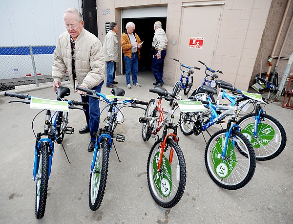 Jim Ryan of Columbia Falls loads up a bike on Friday morning at Wal-mart in Kalispell.