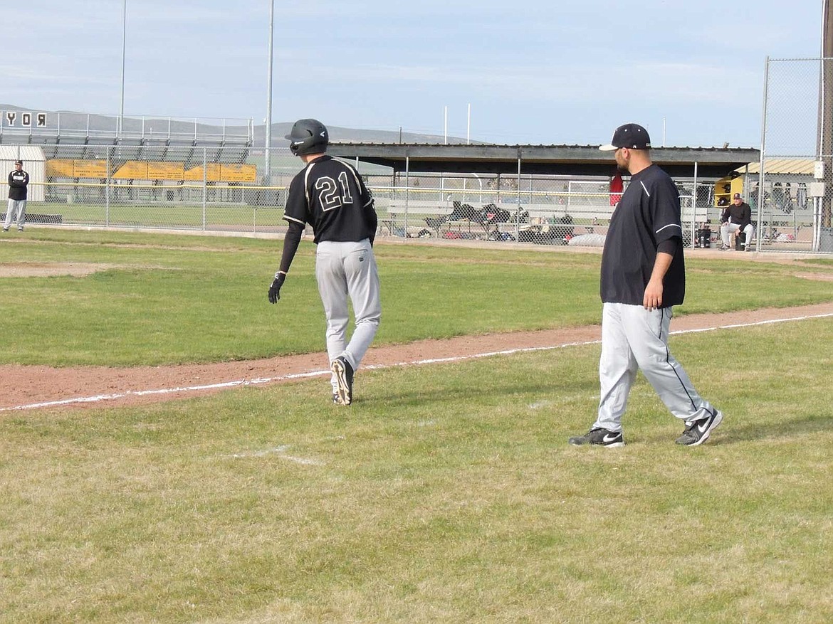 Riley Lefler leads off third base against Newport with coach Joe Avila helping him keep an eye on the defensive action.