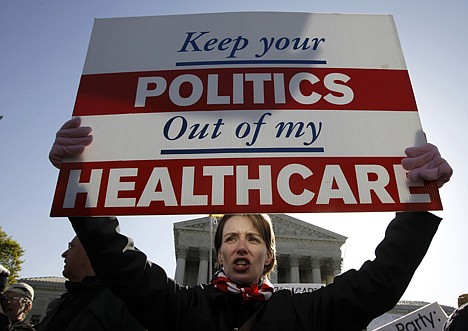 &lt;p&gt;Amy Brighton from Medina, Ohio, who opposes health care reform, rallies in front of the Supreme Court in Washington, Tuesday, March 27, 2012, as the court continues arguments on the health care law signed by President Barack Obama. (AP Photo/Charles Dharapak)&lt;/p&gt;