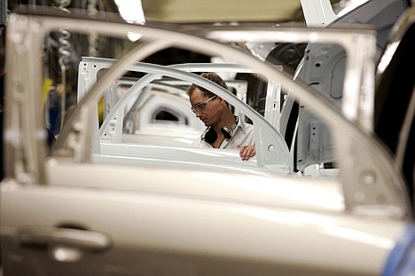 &lt;p&gt;FILE - In this file photo made Dec. 21, 2006, an auto worker installs glass in doors and window openings lined up on the Trim line production of the General Motors' Chevrolet Equinox at the CAMI Automotive facility in Ingersoll, Ontario, Canada. General Motors Co. said Friday, March 26, 2010, it will bring back 600 laid-off auto workers and add equipment at two Canadian factories in an effort make more midsize crossover vehicles that have been selling well in both the U.S. and Canada. (AP Photo/Canadian Press, Dave Chidley, file)&lt;/p&gt;