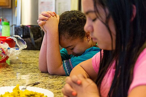 &lt;p&gt;Hailey Rojo, 8, left, prays alongside her sister Jeannette, 11, before eating breakfast.&lt;/p&gt;