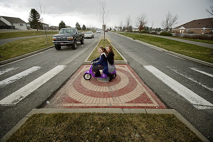 &lt;p&gt;JEROME A. POLLOS/Press Lyndsey Frank, 10, gives her friend Hannah Lakey, 10, a ride on her battery-powered moped after getting out of school Friday at Skyway Elementary in Coeur d'Alene.&lt;/p&gt;