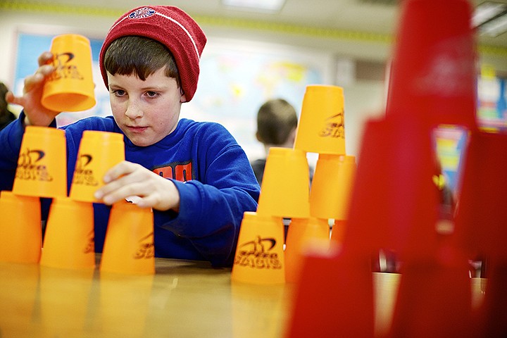 &lt;p&gt;JEROME A. POLLOS/Press Ethan Taylor, 7, practices his cup stacking skills Monday during the After School Enrichment classes at Fernan Elementary in Coeur d'Alene. The classes ranging from African marimbas to scrapbooking are part of a weekly program for more than 100 students held three Mondays and ending on March 25.&lt;/p&gt;