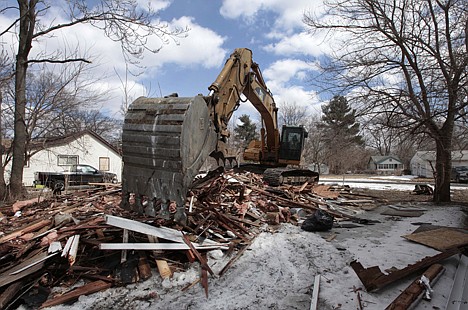 &lt;p&gt;A excavator tears down a house in Detroit's Brightmoor area Monday. For years, Brightmoor area residents pleaded with the city to demolish vacant homes that scavengers have stripped of wiring and plumbing and anything of value. Some structures are already gone, and now officials aim to do much more, possibly tearing down as many as 450 empty houses each week across more than 20 square miles of this bankrupt city.&lt;/p&gt;