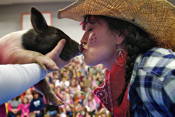 &lt;p&gt;JEROME A. POLLOS/Press Lisa Pica, principal of Hayden Meadows Elementary, kisses a two-week-old pig during an assembly Friday at the school.&lt;/p&gt;