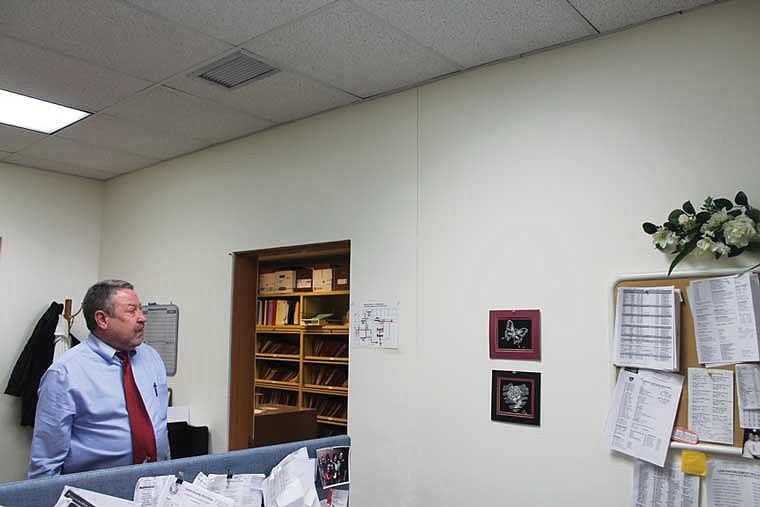 Grant County Juvenile Detention Center Director Warren Swanson looks at a crack in the reception area of the center. Many cracks like this one have formed about 200,000 gallons of water swept away part of the building foundation in January.