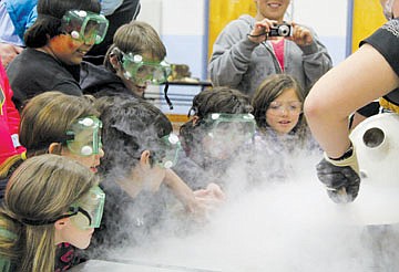 &lt;p&gt;People gather around as spectrUM students from the University of Montana make ice cream using liquid nitrogen during Family Science Night at K. William Harvey Elementary School last week.&lt;/p&gt;