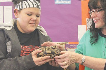 &lt;p&gt;Alizza Finley, left, takes a turn holding Denwen, a bald python, while Peggy Rowe helps out during Family Science Night at K. William Harvey Elementary School in Ronan last Thursday.&lt;/p&gt;