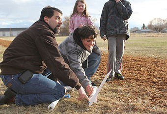 &lt;p&gt;Caden Bourdon, right, eagerly sets up his paper rocket for launch with some help from Bob Cornwell during Family Science Night at K. William Harvey last Thursday.People could build a paper rockets before launching them with compressed air during the event.&lt;/p&gt;